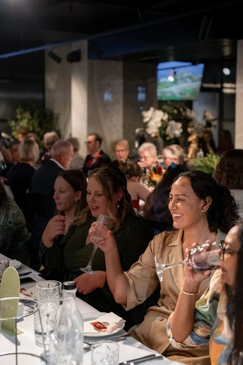 Guests smiling and raising their glasses at a family gathering at La Botte D'Oro, Leichhardt